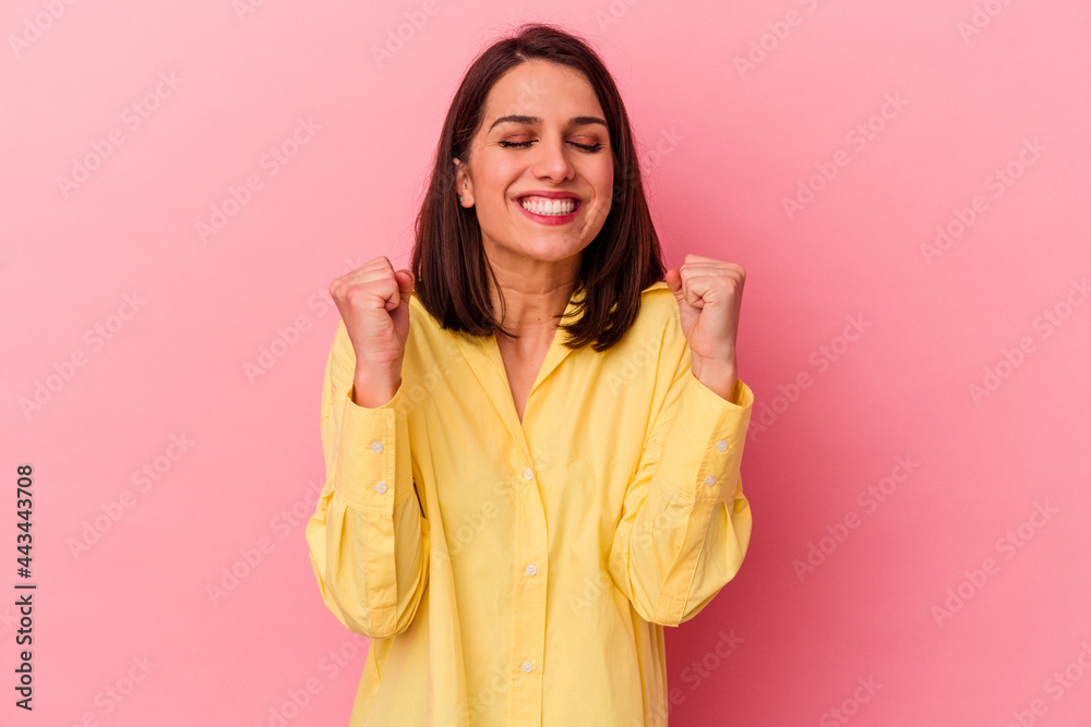 Young caucasian woman isolated on pink background celebrating a victory, passion and enthusiasm, happy expression. Young caucasian woman isolated on pink background celebrating a victory, passion and enthusiasm, happy expression.