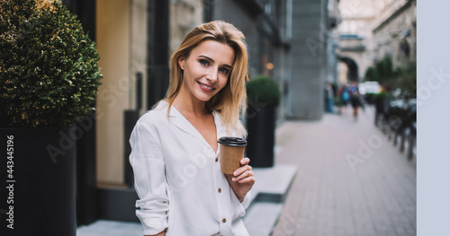 Cheerful woman with cup of coffee