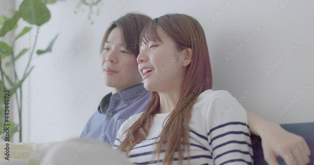 A good-looking Japanese men and women with a relaxing in the living room A good-looking Japanese men and women with a relaxing in the living room