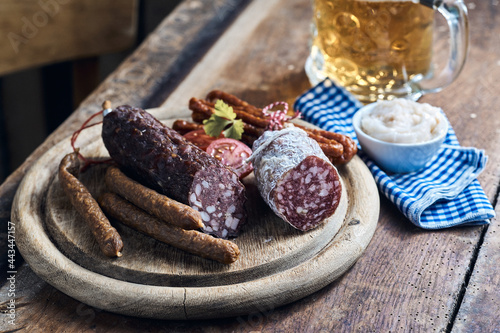 Various meat sausages on wooden table