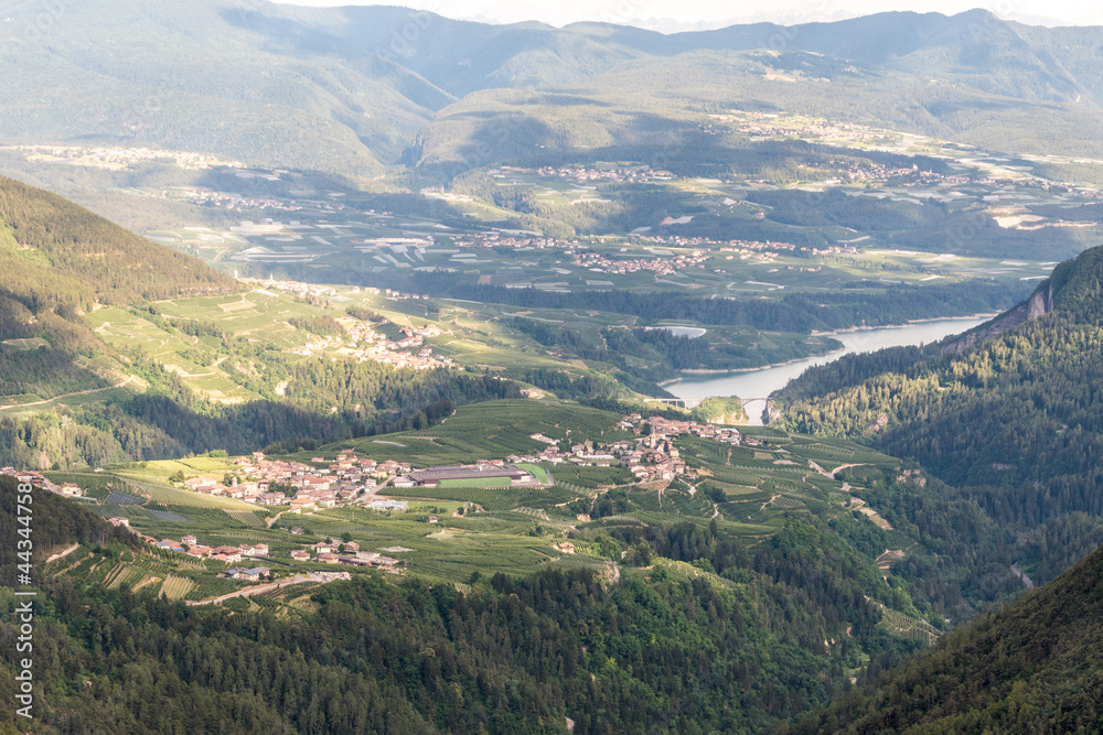 Fototapeta premium The village of Livo and Varollo and the Santa Giustina Lake in Val di Non, Alps, Trentino Alto Adige Südtirol, Italy