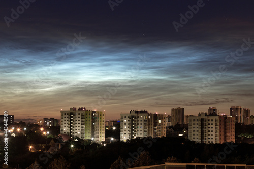 Noctilucent clouds in the night city sky