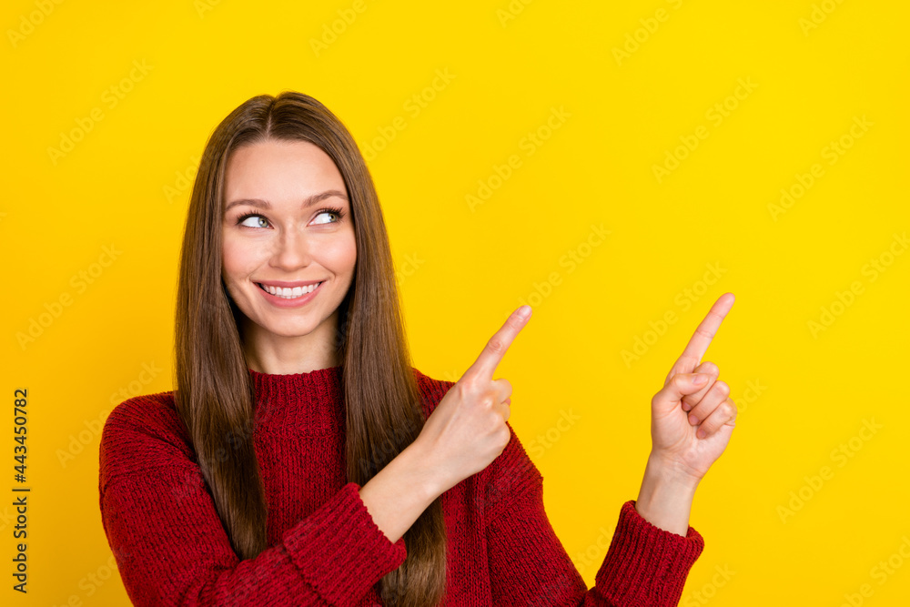 Photo of cheerful young pretty woman look point finger empty space promoter isolated on yellow color background