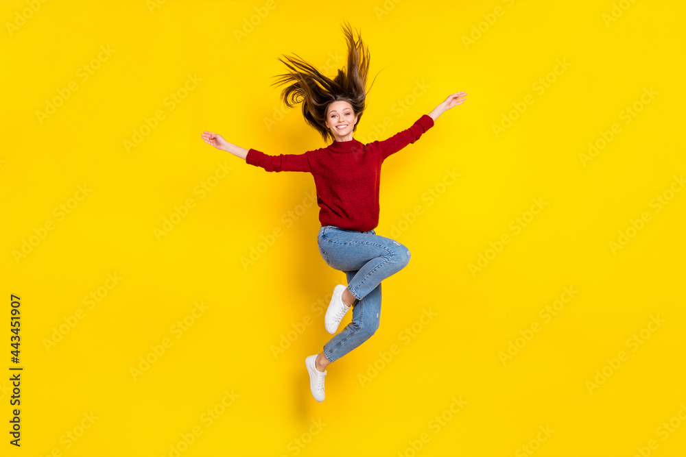 Full size photo of young attractive woman happy positive smile jump active isolated over yellow color background