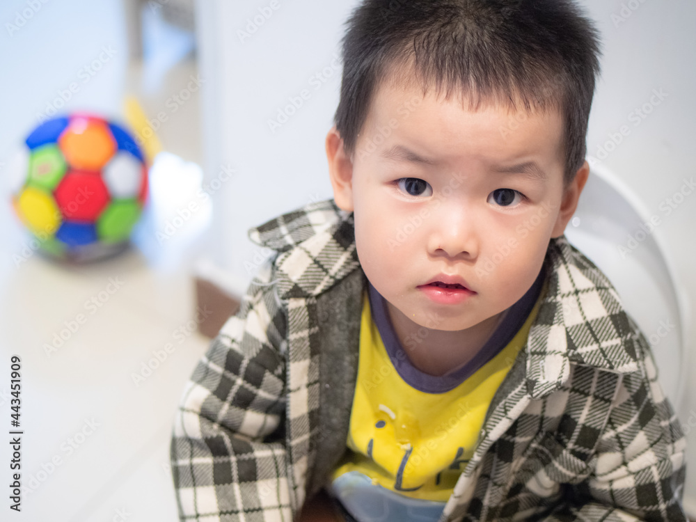 Chinese little boy sitting on a children's toilet