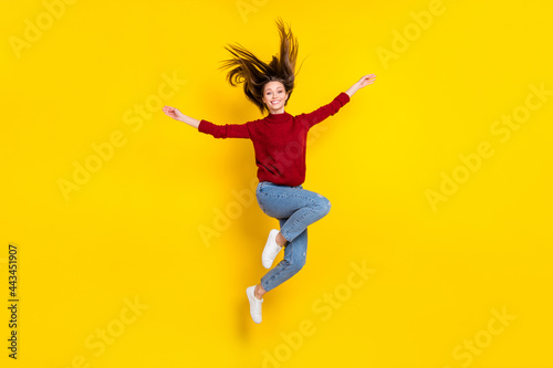Full size photo of young attractive woman happy positive smile jump active isolated over yellow color background