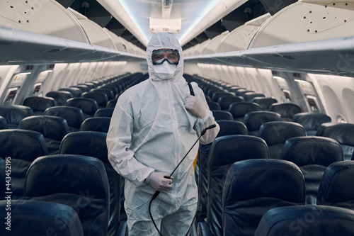 Man in protective gear posing for the camera aboard the plane photo
