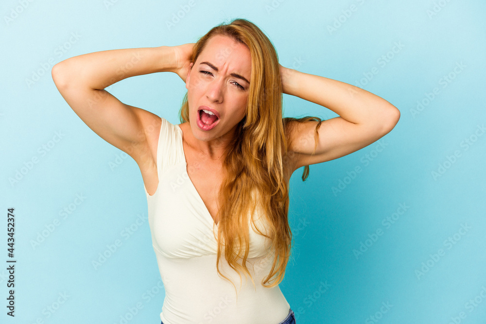 Caucasian woman isolated on blue background screaming, very excited, passionate, satisfied with something. Caucasian woman isolated on blue background screaming, very excited, passionate, satisfied with something.