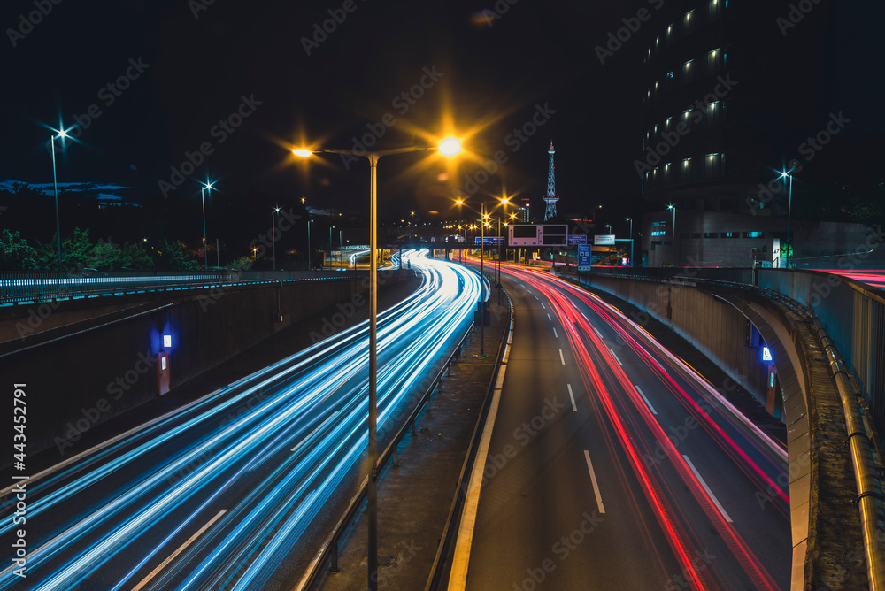 Autobahn 100 in the direction of Messedamm Berlin at night with lightrails, Highway 100 in Berlin germany, lighttrails, Radio Tower Berlin in Background