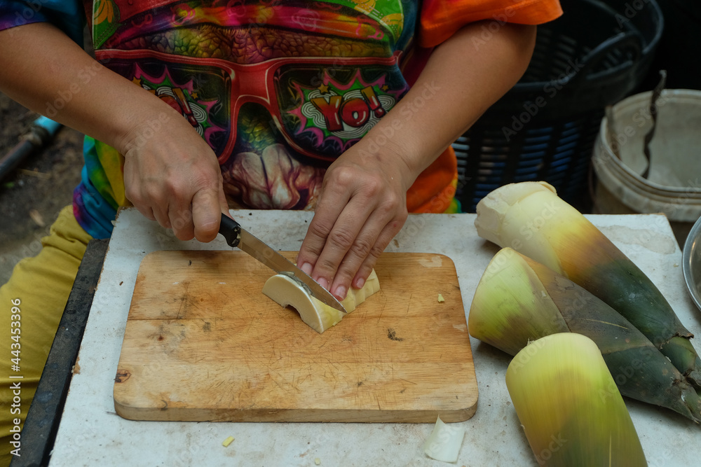 Cook was sliced bamboo shoots,their food is asian Cook was sliced bamboo shoots,their food is asian