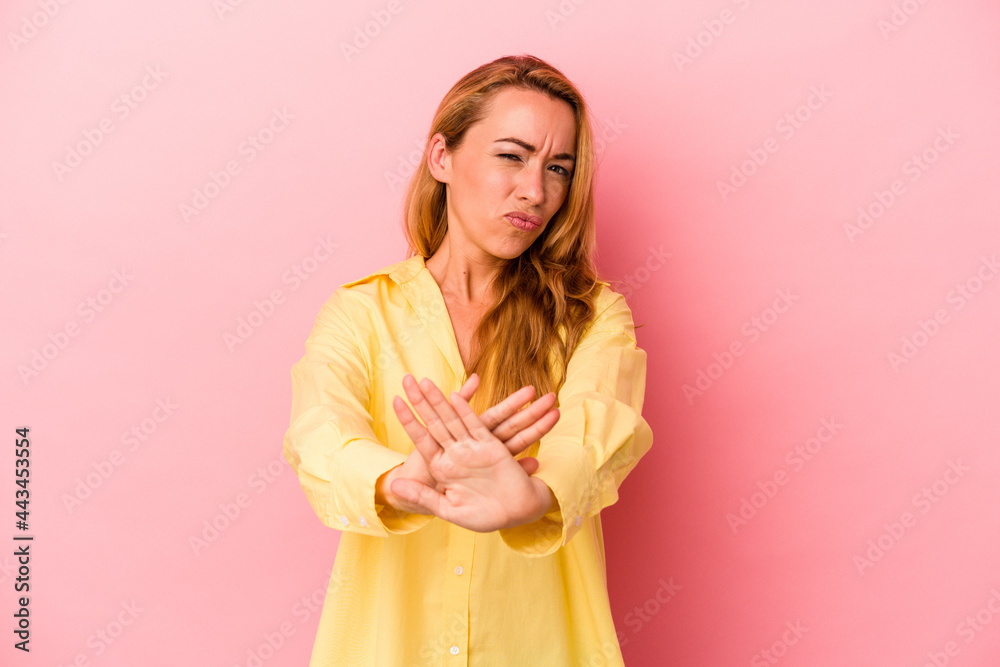 Caucasian blonde woman isolated on pink background standing with outstretched hand showing stop sign, preventing you. Caucasian blonde woman isolated on pink background standing with outstretched hand showing stop sign, preventing you.