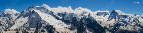 Panoramic view from Mount Mussa-Achitara to the snow-capped Caucasus mountains. Mount Belalakaya 3861 meters is the most recognizable peak of Dombai. Dombai, Karachay-Cherkess Republic, Russia © lexosn