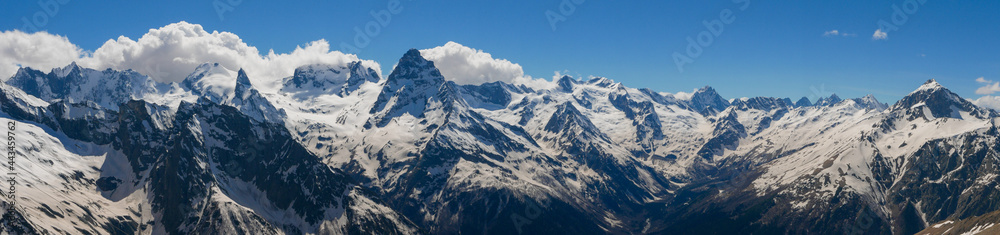 Panoramic view from Mount Mussa-Achitara to the snow-capped Caucasus mountains. Mount Belalakaya 3861 meters is the most recognizable peak of Dombai. Dombai, Karachay-Cherkess Republic, Russia