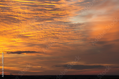 Dramatic fiery bloody sky. Fantastic golden sunset.