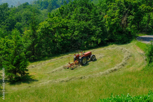 tractor working in the field. Hay bailing, hay harvesting. Agricultural industry