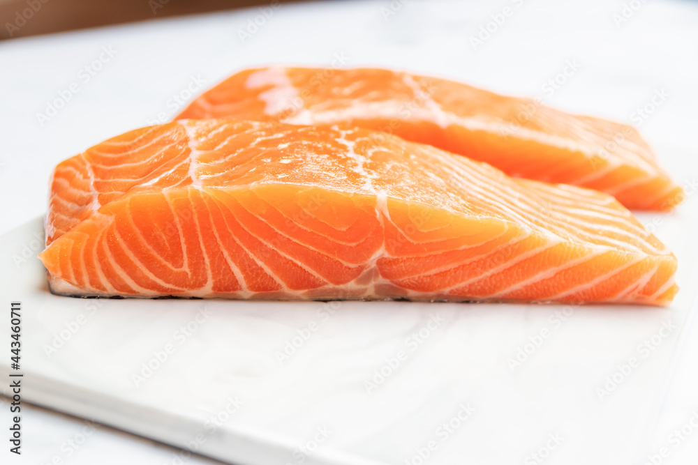 Fresh salmon fillet on marble plate for delicious salmon steak. Fresh salmon fillet on marble plate for delicious salmon steak.