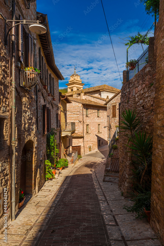 Spello charming historic center lane with an old church bell tower