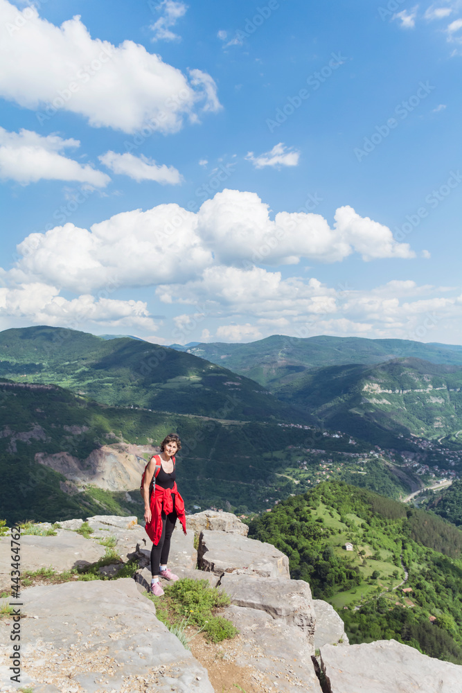 Tourist  Woman with Backpack on the Top of Summer  Mountain with Stunning View. Summer Mountain in Bulgaria, Bov Village, Balkan Mountain, Iskar Gorge