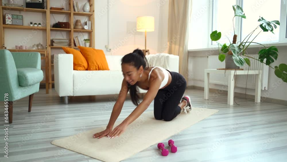 Asian yoga instructor talk about plank pose while looking at camera. Asian sport coach woman teach