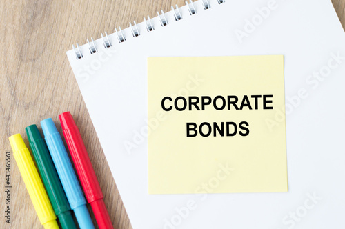 A yellow sticker with text Corporate Bonds is in a Notepad. Business and financial concept