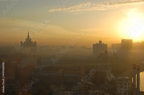 Yellow sunrise over hazy city of Moscow