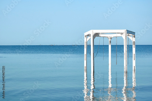 Wooden white arches on the beach. Summer vacation