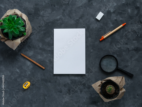 White blank notebook mockup dark background flat lay. Minimal work space sketchbook template, eco paper pen, green plant top view. Back to school banner, stationery, office tools education e-learning