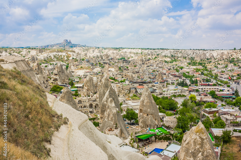 Göreme, Turkey - panorama view of the town of Göreme in Cappadocia, Turkey with fairy chimneys, houses, and unique rock formations seen from sunrise point