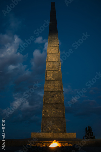 Monument to the Unknown Soldier with eternal fire in the evening. War memorial located in the Ukrainian capital of Kyiv. Park of Eternal Glory. Ukraine