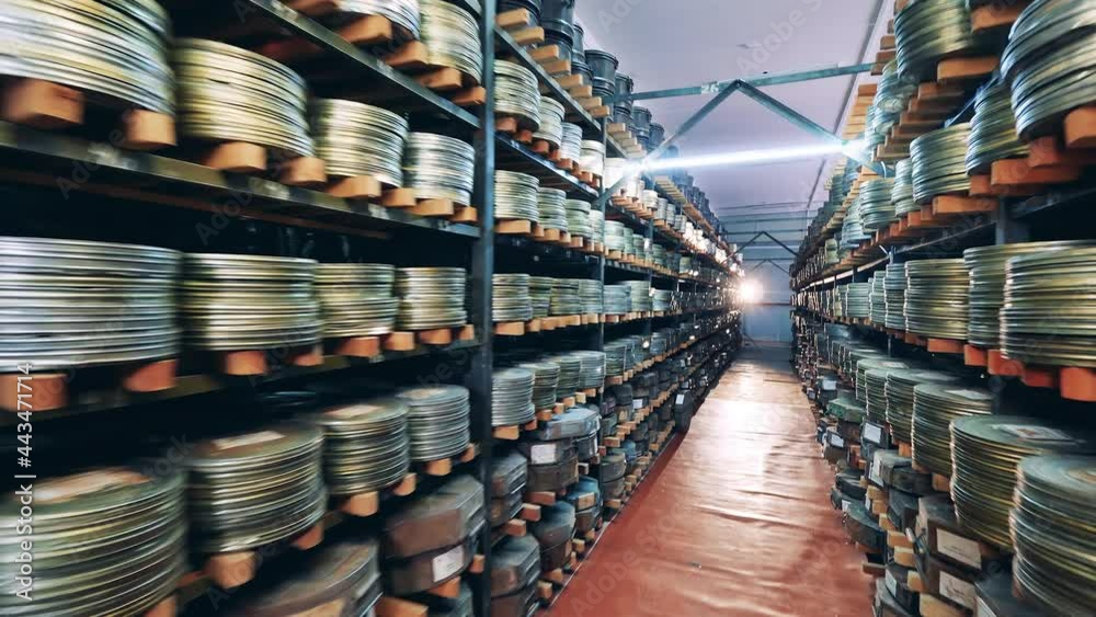 Retro, vintage technology concept. Movie cases on the shelves in the vintage cinema archive