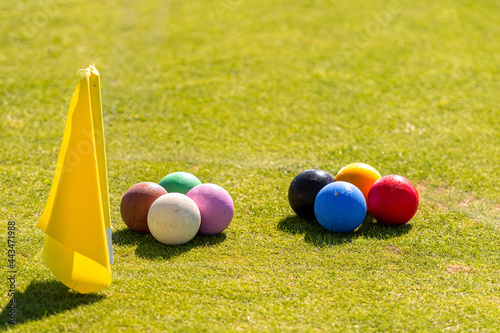 Photography a set of colored croquet balls on the green lawn before the game
