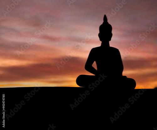 silhouette of buddha at sunset © juancarlos