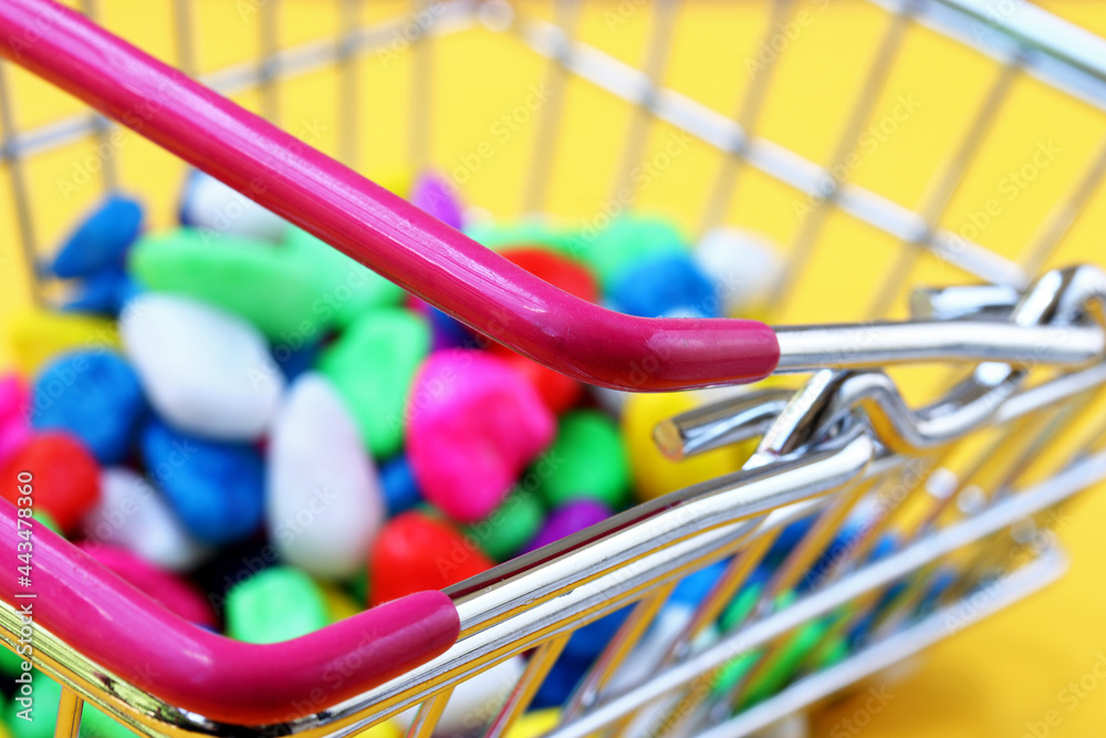 a lot of colorful candies in shopping cart