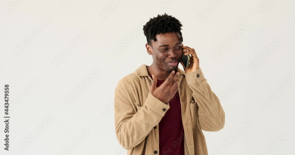 Happy man talking on mobile phone over white background Happy man talking on mobile phone over white background