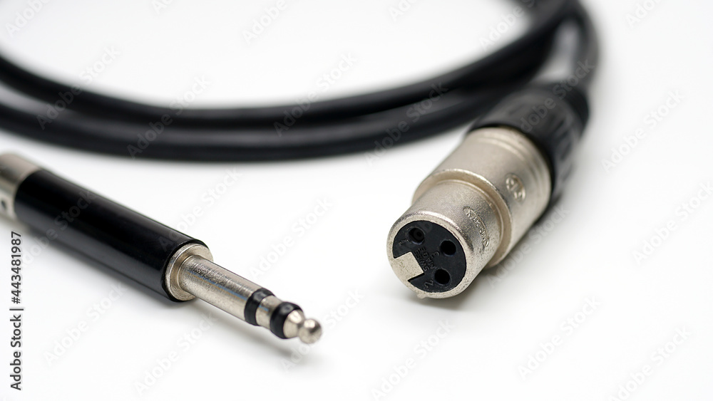 Audio cable with XLR and TRS jack connectors for microphones and professional audio equipment on white background. Audio cable with XLR and TRS jack connectors for microphones and professional audio equipment on white background.