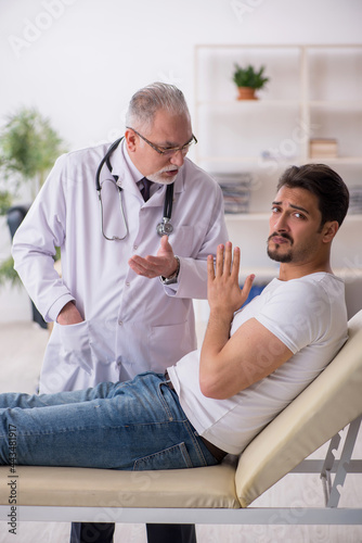 Young male patient visiting old male doctor