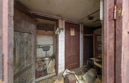 An old Soviet toilet in an abandoned shelter. With a calendar on the door from 1977