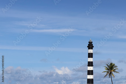  Lighthouse, coconut tree and blue sky on the beach photo