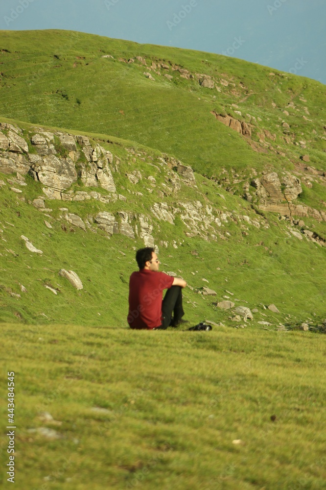 Fototapeta premium Candid shot a young male model enjoying the beauty of nature