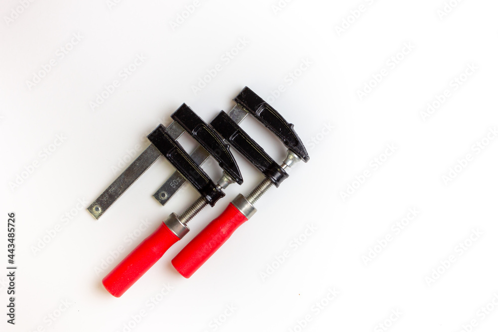 Clamp on a white background. Space for the text. An isolated hand tool. Clamp on a white background. Space for the text. An isolated hand tool.