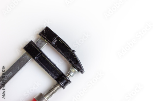 Clamp on a white background. Space for the text. An isolated hand tool.