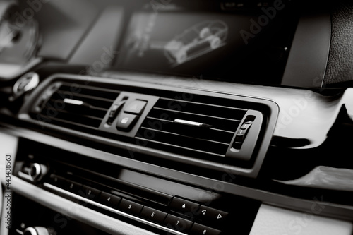 Close up Air Vent in modern car. Ventilation vents with air flow deflectors and display.