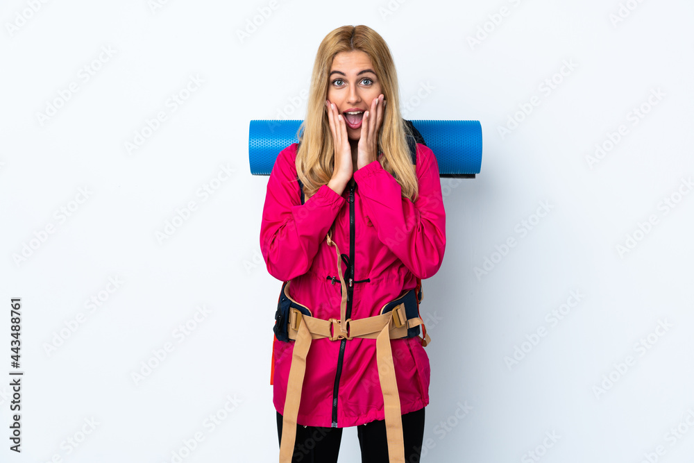 Young mountaineer woman with a big backpack over isolated white background with surprise facial expression Young mountaineer woman with a big backpack over isolated white background with surprise facial expression