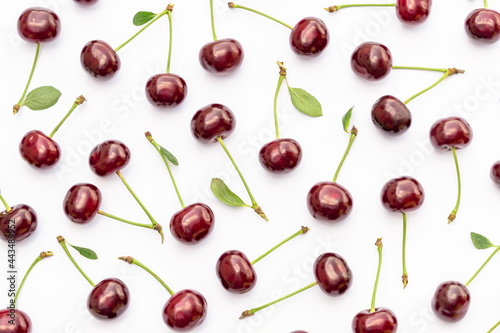 Cherry pattern. Flat lay of cherries and leaves on white background. Food background. Cherries flat design. Top view  flat lay.