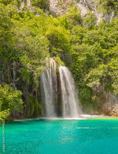 Long exposure waterfall during the day. green forest and rocky mountain. summer time at Plitvice Lakes in Croatia. crystal clear blue water