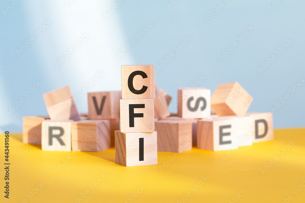 CFI written on wooden cubes, yellow background