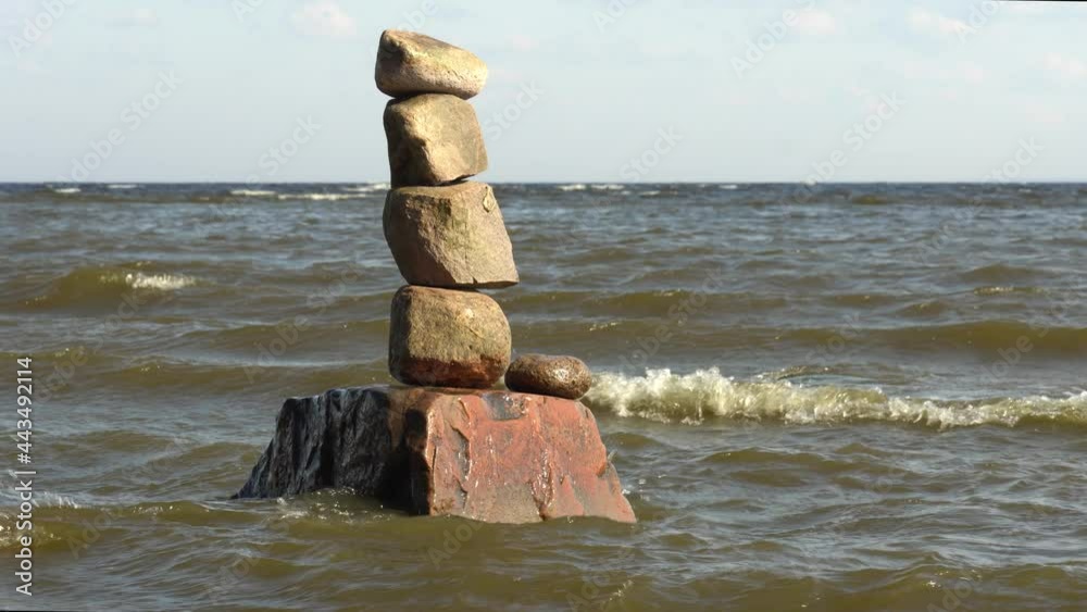 Rock balancing in Gulf of Finland. stones on top of each other. Sea small waves. High quality 4k footage Rock balancing in Gulf of Finland. stones on top of each other. Sea small waves. High quality 4k footage
