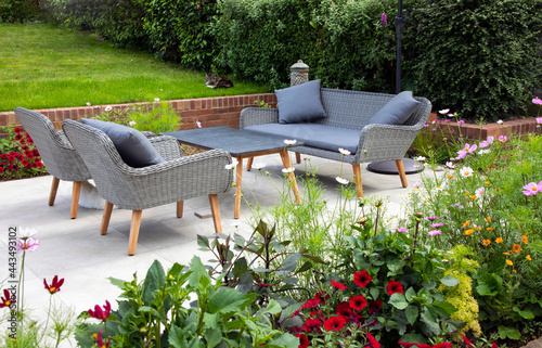 Fototapeta Naklejka Na Ścianę i Meble -  Garden seating next to the flower border