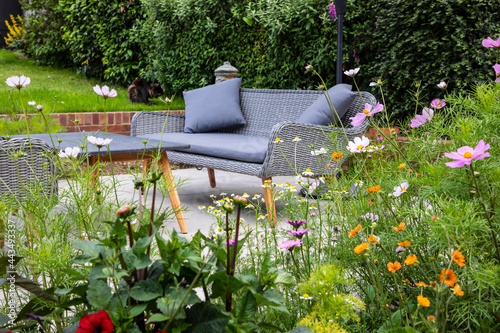 Fototapeta Naklejka Na Ścianę i Meble -  Garden seating next to the flower border