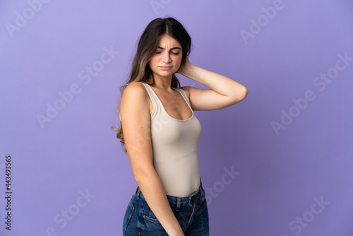 Young caucasian woman isolated on purple background with neckache